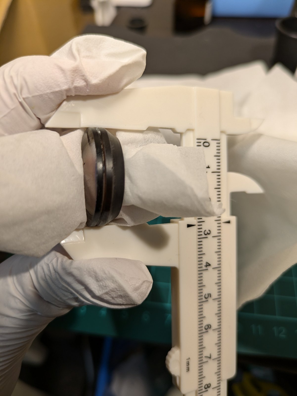 The pair between the jaws of a caliper to line up the edges