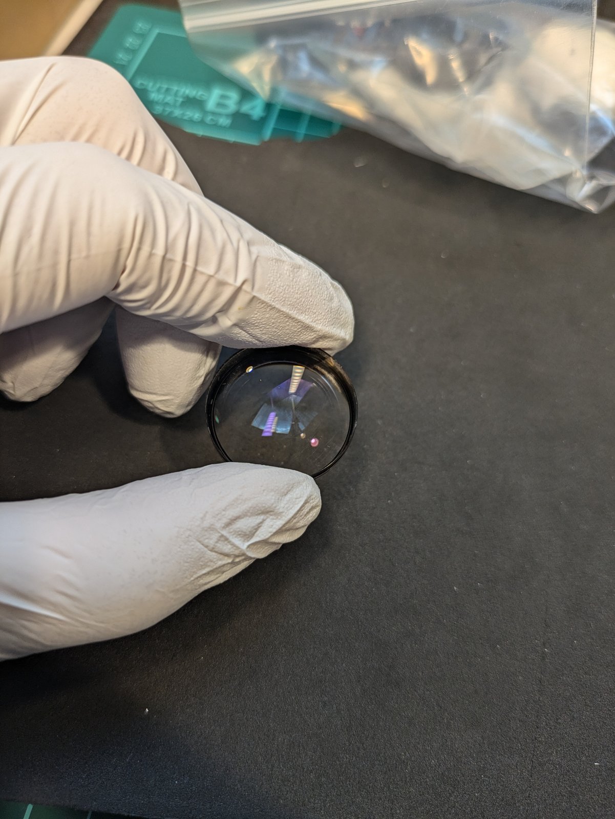 The re-cemented pair, clear, held in gloves